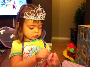 Princess Butterfly gets to open finger puppets (notice the hockey in the background. sigh)